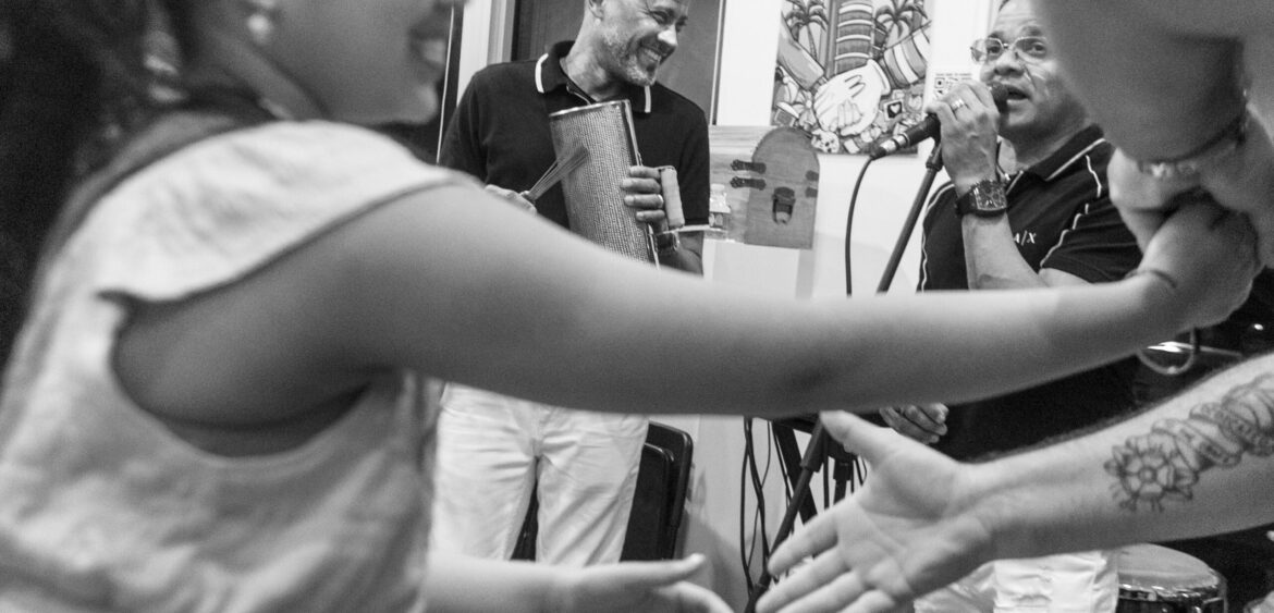 Photographs from the opening night of Carlos Solano’s solo exhibition “An Experience of Us” at WYN317 Gallery in Miami, moving from artwork on the walls and guests in conversation to a salsa jam at Toejam Backlot, ending with Solano painting live.