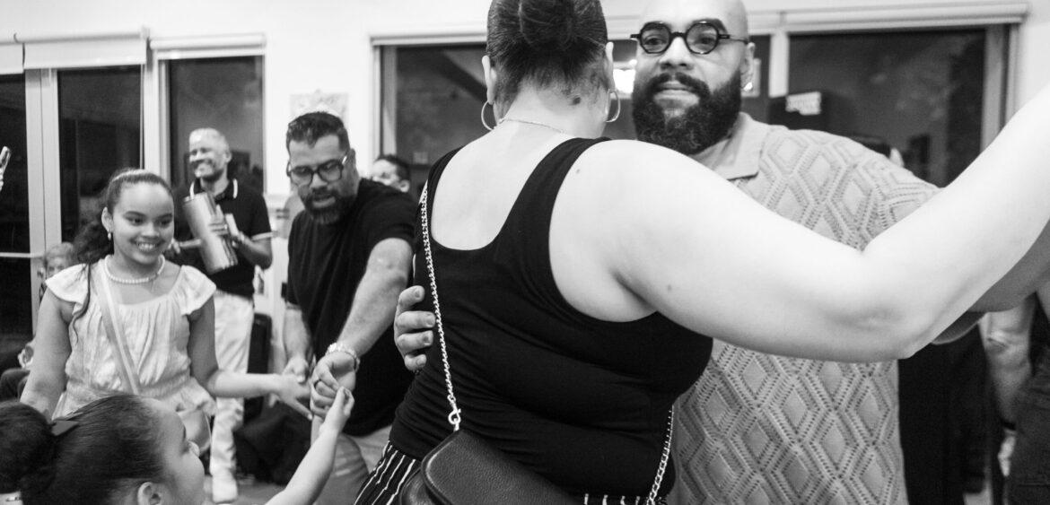 Photographs from the opening night of Carlos Solano’s solo exhibition “An Experience of Us” at WYN317 Gallery in Miami, moving from artwork on the walls and guests in conversation to a salsa jam at Toejam Backlot, ending with Solano painting live.