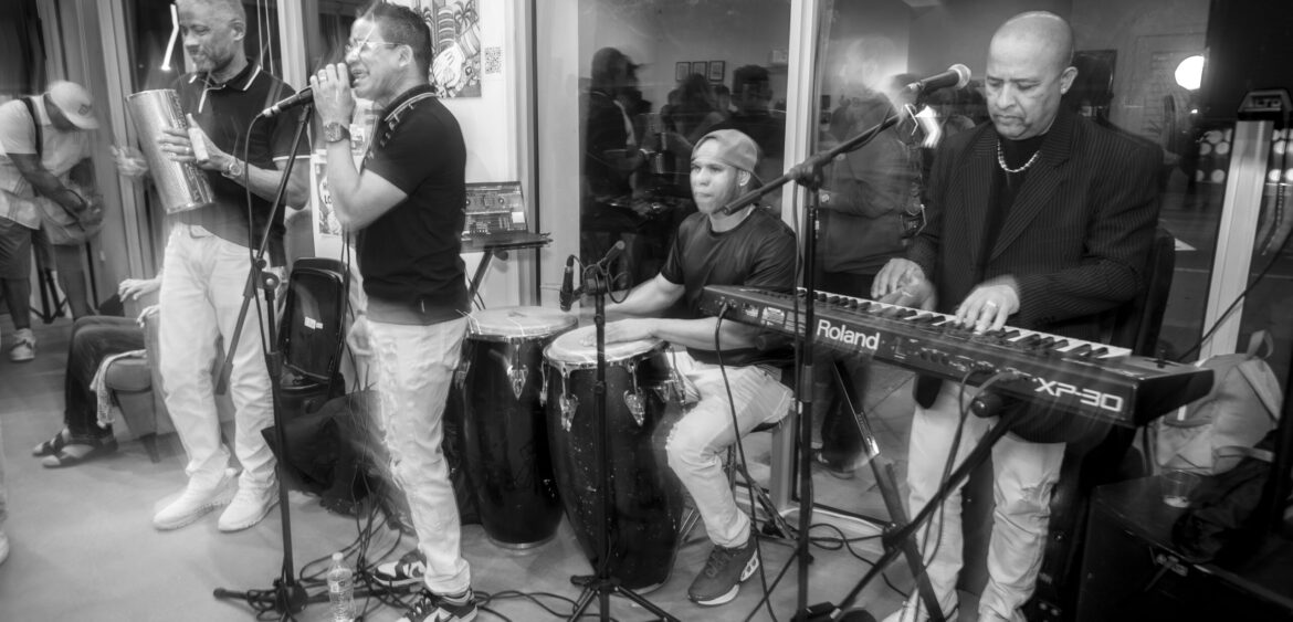 Photographs from the opening night of Carlos Solano’s solo exhibition “An Experience of Us” at WYN317 Gallery in Miami, moving from artwork on the walls and guests in conversation to a salsa jam at Toejam Backlot, ending with Solano painting live.