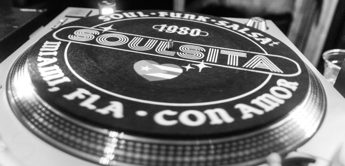 Photographs from the opening night of Carlos Solano’s solo exhibition “An Experience of Us” at WYN317 Gallery in Miami, moving from artwork on the walls and guests in conversation to a salsa jam at Toejam Backlot, ending with Solano painting live.