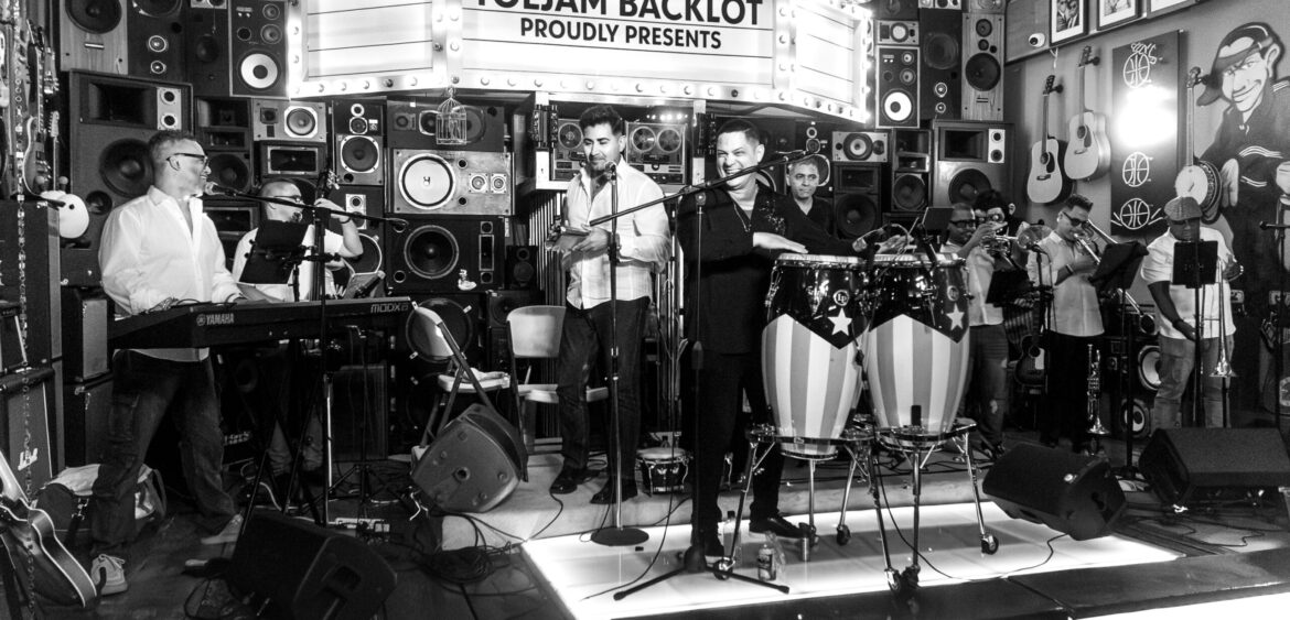 Photographs from the opening night of Carlos Solano’s solo exhibition “An Experience of Us” at WYN317 Gallery in Miami, moving from artwork on the walls and guests in conversation to a salsa jam at Toejam Backlot, ending with Solano painting live.