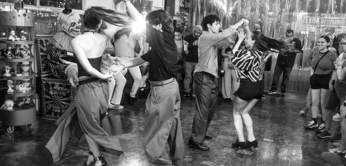 Photographs from the opening night of Carlos Solano’s solo exhibition “An Experience of Us” at WYN317 Gallery in Miami, moving from artwork on the walls and guests in conversation to a salsa jam at Toejam Backlot, ending with Solano painting live.