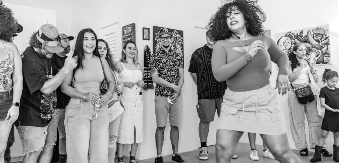 Documentary photograph from Sunset Rumba at WYN317 in Miami, showing live music and gallery activity during the closing reception for Carlos Solano’s exhibition “An Experience of Us.”