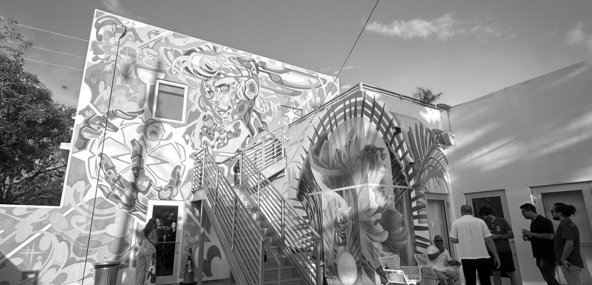 Documentary photograph from Sunset Rumba at WYN317 in Miami, showing live music and gallery activity during the closing reception for Carlos Solano’s exhibition “An Experience of Us.”